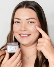 Woman applying a product to her face with a container labeled 'Pink Surf' in the foreground.